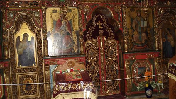 Gilded iconostasis with Byzantine icons, Gospel on red-clothed table