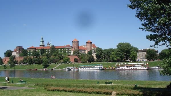Wawel Castle with red brick towers seen across the Vistula river