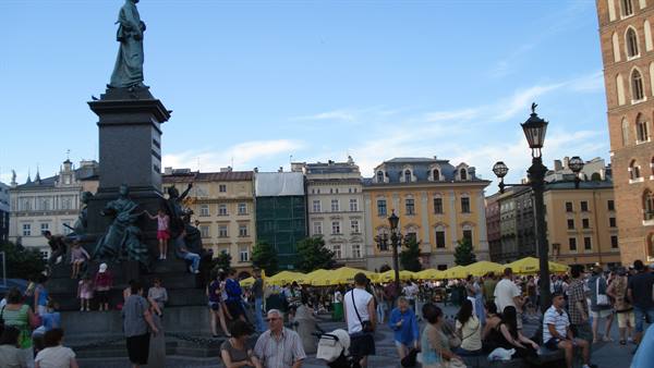 Crowds around the Mickiewicz monument on Kraków's bustling main square