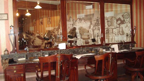Vintage barber shop with wooden chairs, mirrors and old lamps