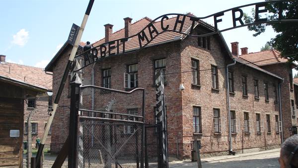 Arbeit Macht Frei gate and red brick building at Auschwitz