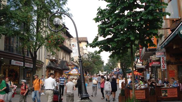 Tourists strolling on a pedestrian street with outdoor cafes, Krupówki Zakopane