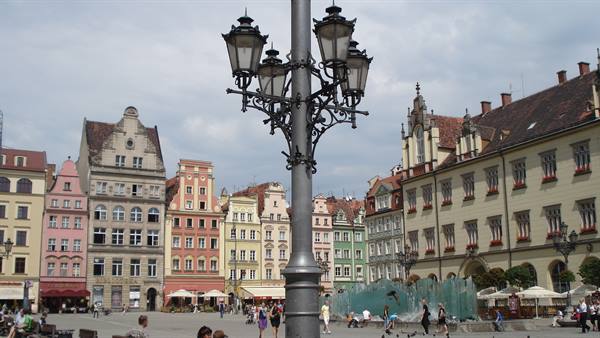 Wrocław market square, wrought-iron lamppost, colorful houses and a glass fountain