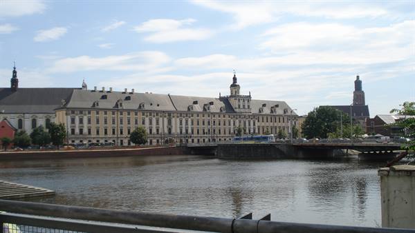 Long baroque building on the Odra river with bridge and bus, Wrocław University