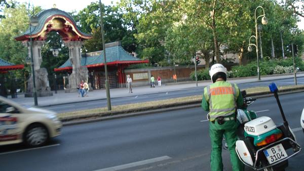 Police officer on motorcycle near the Elephant Gate of Berlin Zoo