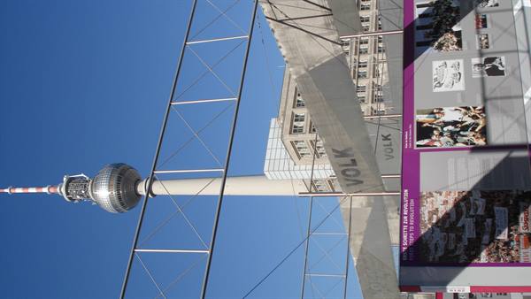 Berlin TV Tower seen from below through scaffolding and display panels