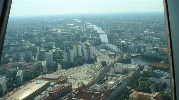 Berlin from above: the Spree river winds among buildings in hazy light