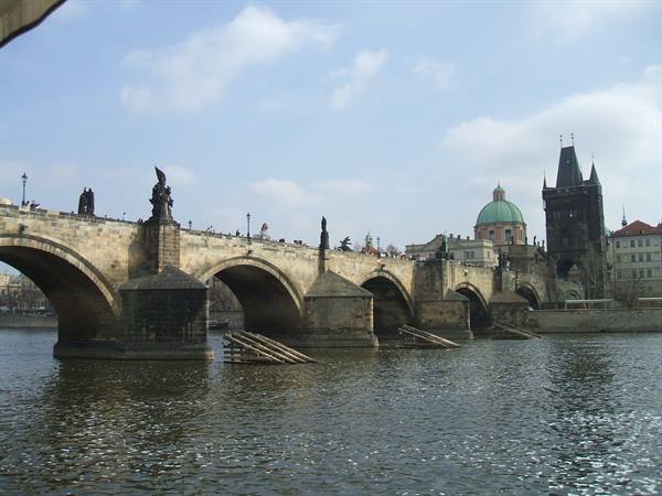 Charles Bridge in Prague: stone arches and statues over the Vltava