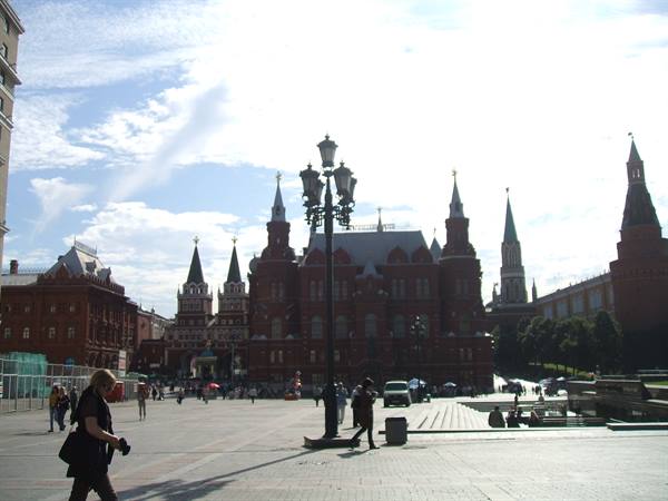 Tourists walk on Red Square in front of Moscow's Historical Museum