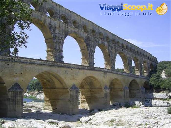 Pont du Gard, ancient Roman stone aqueduct with arches above the river