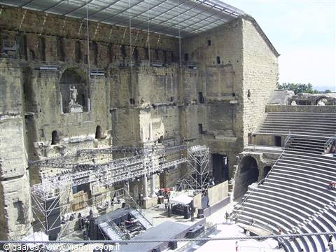 Roman theatre of Orange, stone stage wall and tiered seating with metal stage rigging