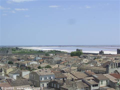 Terracotta rooftops and medieval walls of Aigues-Mortes before the salt marshes