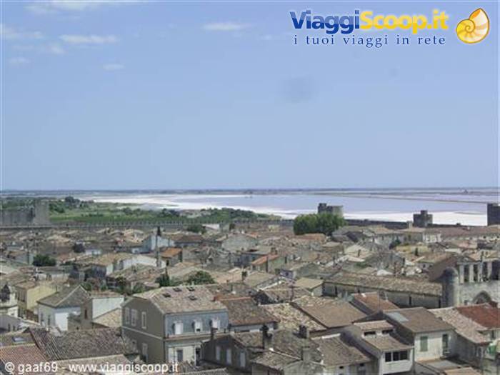 Terracotta rooftops and medieval walls of Aigues-Mortes before the salt marshes