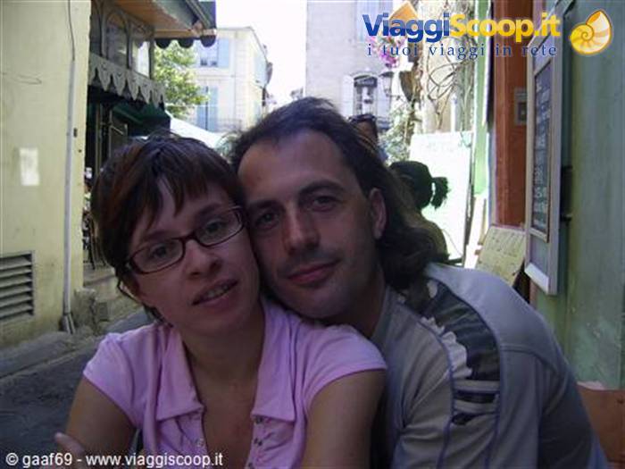 Selfie of a couple in a narrow alley between colorful houses
