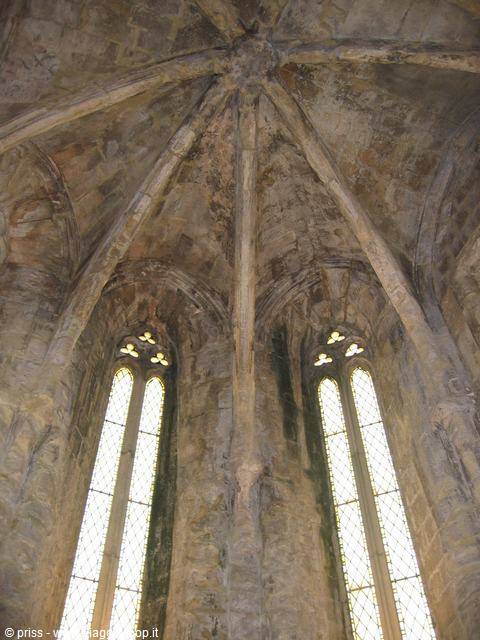 Gothic stone vault and tall pointed windows flooding the hall with white light
