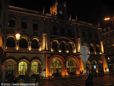 Rossio Station in Lisbon, stone facade lit at night with Moorish arches