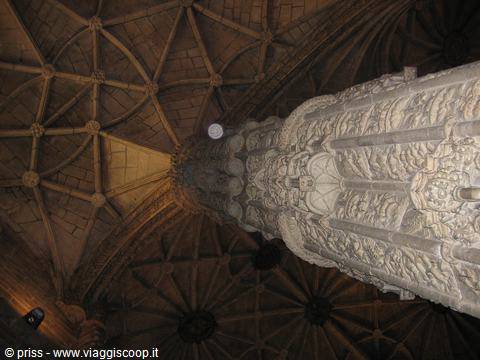 Carved stone pillar and gothic vaulted ceiling, Jerónimos Monastery, dim light