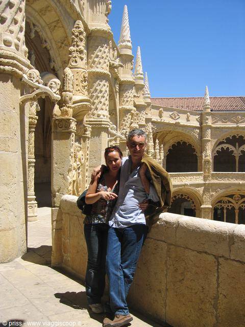 Couple in the Jerónimos Monastery cloister, carved Manueline limestone in Lisbon