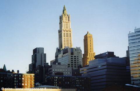 White terracotta Woolworth Building tower rising over New York rooftops