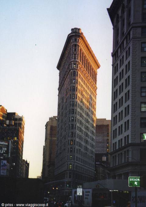 The Flatiron Building in New York glowing in golden light among skyscrapers
