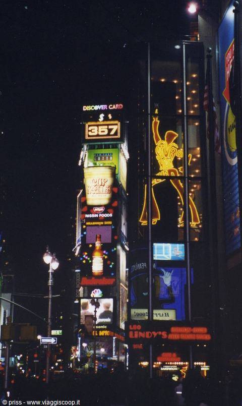 Times Square at night: glowing billboards and a neon Elvis sign above Lindy's