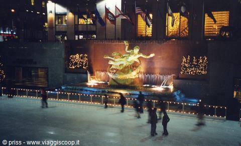 Skaters on the Rockefeller Center rink beneath the golden Prometheus statue