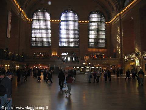 Grand Central Terminal, travelers beneath the three large lit windows