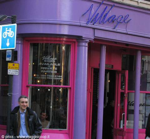 Man walks past the Village bar with purple and pink facade in Soho, London