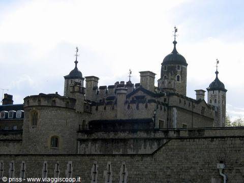 The green-domed turrets of the Tower of London rise against white clouds