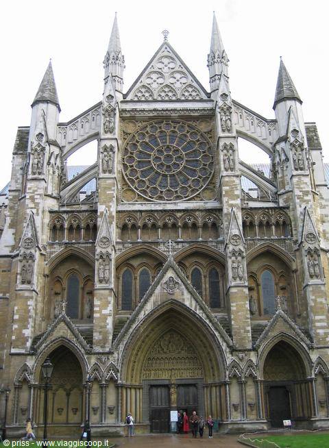 Gothic facade of Westminster Abbey with stone rose window and tourists