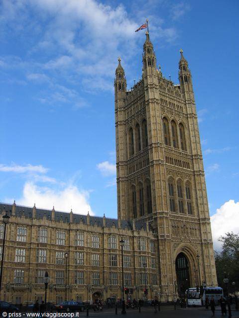 Victoria Tower of Parliament at Westminster, golden stone under blue sky