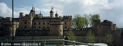 Tower of London: medieval stone walls and turrets with flags under cloudy sky