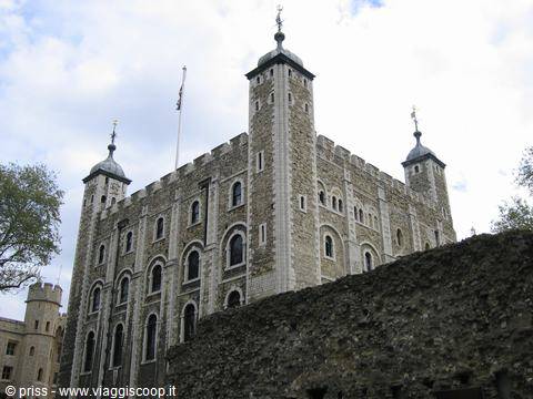 The Tower of London, pale stone fortress with four turrets, under a cloudy sky