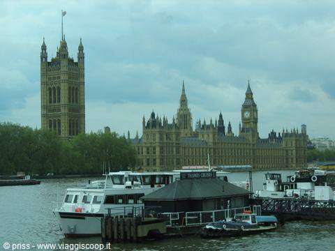 Boats moored on the Thames in front of the Palace of Westminster and Big Ben