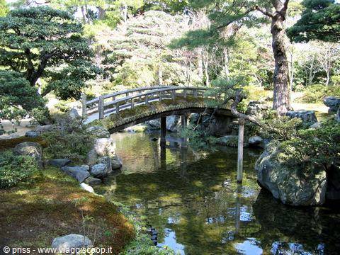Wooden arched bridge over the pond at Sento Imperial Garden, Kyoto