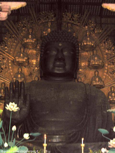 Great bronze Buddha at Todai-ji temple, raised hand, golden halo, lotus flowers