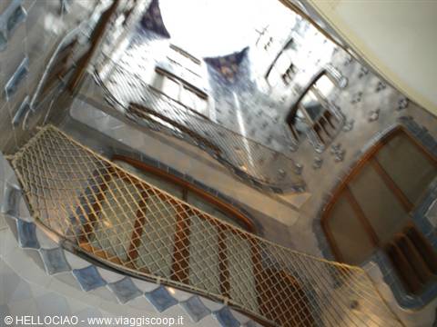 Casa Batlló: blue-tiled courtyard with rope-net balcony, daylight