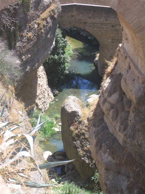 Stone bridge in Ronda spanning the river between rocky cliffs