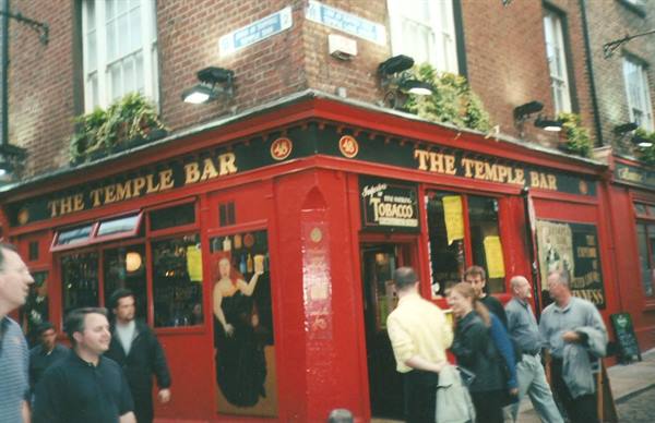 People outside the red Temple Bar pub in Dublin