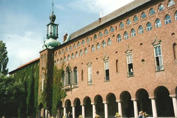Stockholm City Hall, red brick facade with arcades and green spire