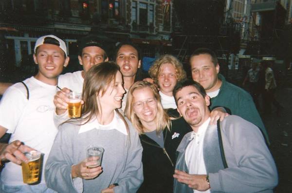 Group of friends drinking beer, joking at night on the street