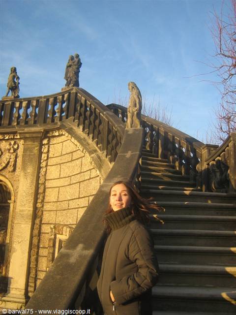 Girl in front of the baroque staircase of the Dresden Zwinger with statues