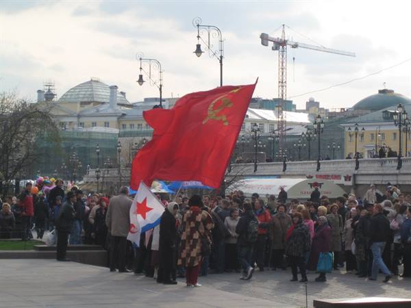 Demonstration in Moscow: crowd waving red hammer and sickle flag