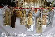 Golden Buddhist amulets hanging together, warm light