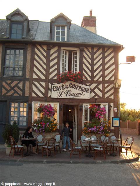 Café du Coiffeur J. Vincent, timbered Norman house with flowers and outdoor café tables