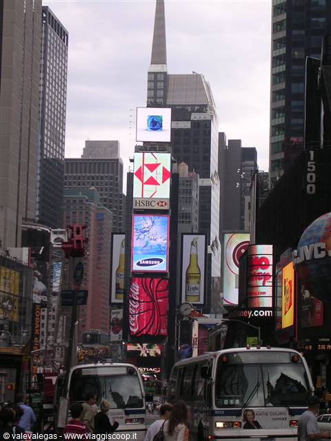 Times Square: buses and skyscrapers with bright HSBC, Samsung and Coca-Cola billboards