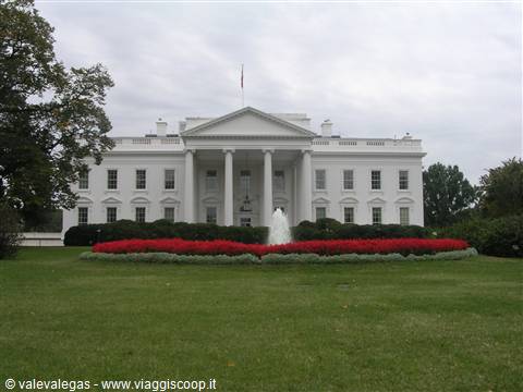 The White House with fountain and red flowerbeds under grey sky