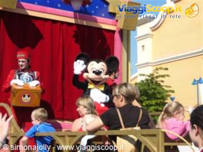 Mickey Mouse waving from a parade float at Disneyland