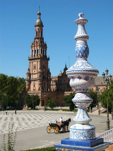 Seville's Plaza de España: blue ceramic lamp post, horse carriage and brick tower