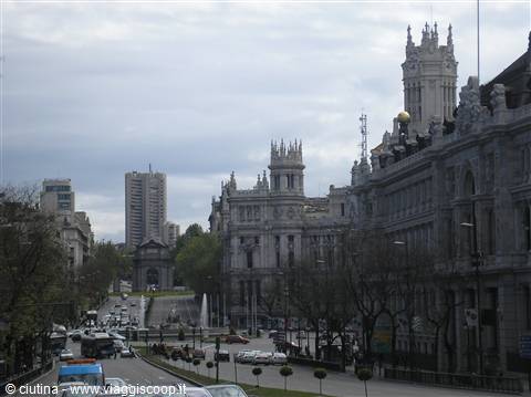 Cibeles Palace and fountain in Madrid, traffic under cloudy sky